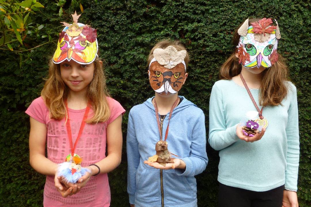 Children wearing masks made at the Awesome owls chidlren's event