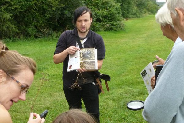 Walk leader showing a picture of the purse web spider