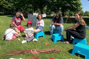 families enjoy making mandalas in the sunshine