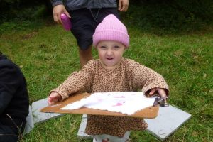 A preschooler creating on the Downs